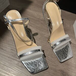 Brand NEW silver low heels size 7! Never warn